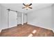 Bedroom features wood floors, a ceiling fan and a sliding barn door with closet at 1893 Burning Tree Dr, Decatur, GA 30032
