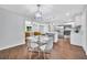 Bright dining room with glass table and kitchen in background with stainless steel appliances at 1893 Burning Tree Dr, Decatur, GA 30032