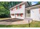 Close-up of home's entrance, features a well-maintained lawn, gray steps, and olive front door at 1893 Burning Tree Dr, Decatur, GA 30032