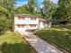 Beautiful exterior view of home featuring lush greenery and long drive way at 1893 Burning Tree Dr, Decatur, GA 30032