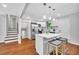 Charming kitchen with white cabinets, stainless steel appliances, breakfast bar, and hardwood floors at 1893 Burning Tree Dr, Decatur, GA 30032