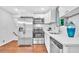 Updated kitchen with stainless steel appliances, white cabinets, and marble backsplash at 1893 Burning Tree Dr, Decatur, GA 30032
