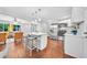Open-concept living space featuring stainless steel appliances, breakfast bar, and hardwood floors at 1893 Burning Tree Dr, Decatur, GA 30032