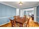 Spacious dining room featuring hardwood floors and view into the living room creating an open and inviting space at 3369 Arbor Path Dr, Atlanta, GA 30340