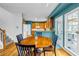 Eat-in kitchen with wooden table and chairs, with a view of the outside deck at 3369 Arbor Path Dr, Atlanta, GA 30340