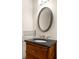 Bathroom featuring a stylish vanity with a dark countertop, oval mirror, and modern fixtures at 380 Grant Se Cir # 306, Atlanta, GA 30315