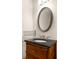 Bathroom vanity featuring dark cabinets, granite countertop, and brushed nickel faucet at 380 Grant Se Cir # 306, Atlanta, GA 30315