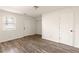 White bedroom with wood floors, a window, and a door leading outside at 380 Grant Se Cir # 306, Atlanta, GA 30315