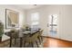 Bright dining area features a sleek table setting, contemporary art, and an access door to the outside at 380 Grant Se Cir # 306, Atlanta, GA 30315