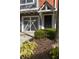 Close up of a townhome front door and single car garage with a driveway and landscaping at 380 Grant Se Cir # 306, Atlanta, GA 30315