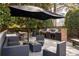 Outdoor kitchen and dining area with grill and shade umbrella at 380 Grant Se Cir # 306, Atlanta, GA 30315