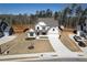 Aerial view of a modern home with beautiful landscaping and long driveway at 4732 Cooling Water Cir, Powder Springs, GA 30127