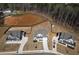Aerial view showing a neighborhood of homes with spacious yards and a pond at 4732 Cooling Water Cir, Powder Springs, GA 30127