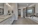 Modern bathroom with double vanity, soaking tub, and glass-enclosed shower at 4732 Cooling Water Cir, Powder Springs, GA 30127