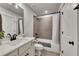 Modern bathroom featuring gray tiled shower and vanity with black hardware at 4732 Cooling Water Cir, Powder Springs, GA 30127