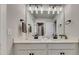 Double sink bathroom vanity with white countertops, modern lighting, and sleek black hardware at 4732 Cooling Water Cir, Powder Springs, GA 30127