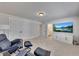 Cozy bonus room with comfortable seating and a large entertainment center; also features ensuite bathroom entrance at 4732 Cooling Water Cir, Powder Springs, GA 30127