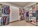 Large walk-in closet with custom shelving and storage for clothes and accessories at 4732 Cooling Water Cir, Powder Springs, GA 30127