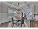 Stylish dining room featuring coffered ceilings, wainscoting, hardwood floors, and abundant natural light, ideal for entertaining at 4732 Cooling Water Cir, Powder Springs, GA 30127