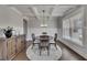 Beautiful dining room boasting coffered ceilings, wainscoting, hardwood floors, and a window, creating a perfect ambiance for dining at 4732 Cooling Water Cir, Powder Springs, GA 30127