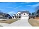 Well-maintained two-story home showcasing a light brick exterior, a covered entryway, and a spacious driveway leading to the garage at 4732 Cooling Water Cir, Powder Springs, GA 30127