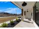 Welcoming front porch adorned with stone pillars, wooden columns, and stylish lighting, offering a cozy outdoor space at 4732 Cooling Water Cir, Powder Springs, GA 30127