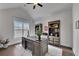 Bright home office with hardwood floors, built-in bookshelves, and a large window, providing a comfortable workspace at 4732 Cooling Water Cir, Powder Springs, GA 30127