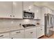 Well-lit kitchen featuring stainless steel appliances, white cabinets, and granite countertops at 4732 Cooling Water Cir, Powder Springs, GA 30127