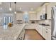 White kitchen with granite countertops, stainless appliances and a view to an outdoor patio at 4732 Cooling Water Cir, Powder Springs, GA 30127