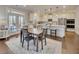 Open kitchen and dining area with stainless steel appliances and large island at 4732 Cooling Water Cir, Powder Springs, GA 30127