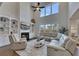 Open living room featuring tall windows, a fireplace, built-in shelving and sectional sofa at 4732 Cooling Water Cir, Powder Springs, GA 30127
