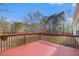 View of the outdoor wooden back deck overlooking the fenced backyard and surrounding foliage at 109 Melrose Creek Dr, Stockbridge, GA 30281