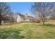 Backyard featuring home's rear exterior, an outdoor wooden deck, and spacious manicured grassy area at 109 Melrose Creek Dr, Stockbridge, GA 30281