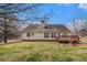 Backyard featuring home's rear exterior, an outdoor wooden deck, and a spacious grassy area at 109 Melrose Creek Dr, Stockbridge, GA 30281