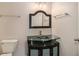 Bathroom featuring a glass bowl sink on a dark vanity with modern light fixture and framed mirror at 109 Melrose Creek Dr, Stockbridge, GA 30281