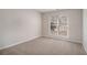 Bedroom with neutral paint, plush carpet, and a large window for natural light at 109 Melrose Creek Dr, Stockbridge, GA 30281