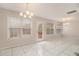 Bright dining area with modern light fixtures, white tile floor, and lots of natural light at 109 Melrose Creek Dr, Stockbridge, GA 30281
