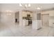 Open kitchen with tile floors, modern appliances, and a view of the fireplace at 109 Melrose Creek Dr, Stockbridge, GA 30281
