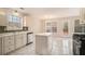 Well-lit kitchen with white cabinetry and island at 109 Melrose Creek Dr, Stockbridge, GA 30281