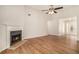 Open-concept living room with a fireplace, wood floors, and plenty of natural light at 109 Melrose Creek Dr, Stockbridge, GA 30281
