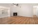 Bright living room with fireplace, ceiling fan and hardwood floors at 109 Melrose Creek Dr, Stockbridge, GA 30281
