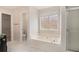 Relaxing bathroom featuring soaking tub, walk-in shower, and walk-in closet access at 109 Melrose Creek Dr, Stockbridge, GA 30281