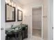 Elegant bathroom featuring double sink vanity, tile floors, and walk-in closet at 109 Melrose Creek Dr, Stockbridge, GA 30281