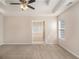 Comfortable bedroom with tray ceiling, carpet flooring, and ensuite bathroom at 109 Melrose Creek Dr, Stockbridge, GA 30281