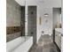 This bathroom features a tub, modern vanity, and stylish dark grey tile throughout at 1101 Juniper Ne St # 519, Atlanta, GA 30309