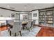 Elegant dining room with large table, bookshelf, and access to outdoor space at 1101 Juniper Ne St # 519, Atlanta, GA 30309