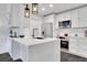 Modern white kitchen with stainless steel appliances, quartz countertops, and stylish pendant lighting at 1101 Juniper Ne St # 519, Atlanta, GA 30309