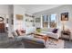 Bright living room featuring large window, white sofa with purple pillows, and charming decor at 1101 Juniper Ne St # 519, Atlanta, GA 30309