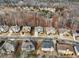 An aerial view showcases a well-planned residential neighborhood with manicured lawns and tree-lined streets at 2536 Kachina Trl, Dacula, GA 30019