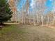 Expansive backyard with lush green lawn and mature trees, perfect for outdoor activities and relaxation at 2536 Kachina Trl, Dacula, GA 30019
